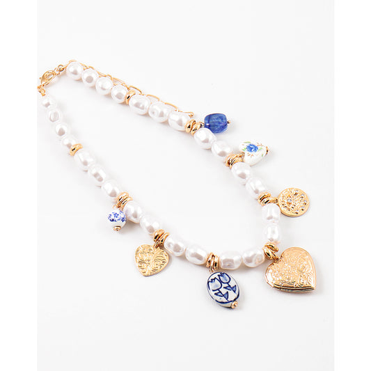 Pearl bracelet with gold and blue charm on a white background