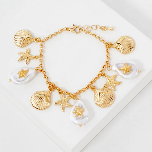 Gold bracelet with shell and starfish charms on a white background -Gaonnori korean cool jewelry